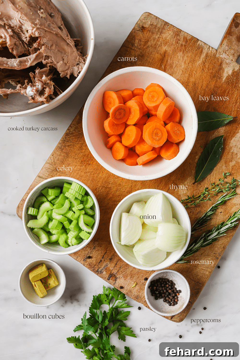 Pre-measured turkey broth ingredients on a cutting board. 