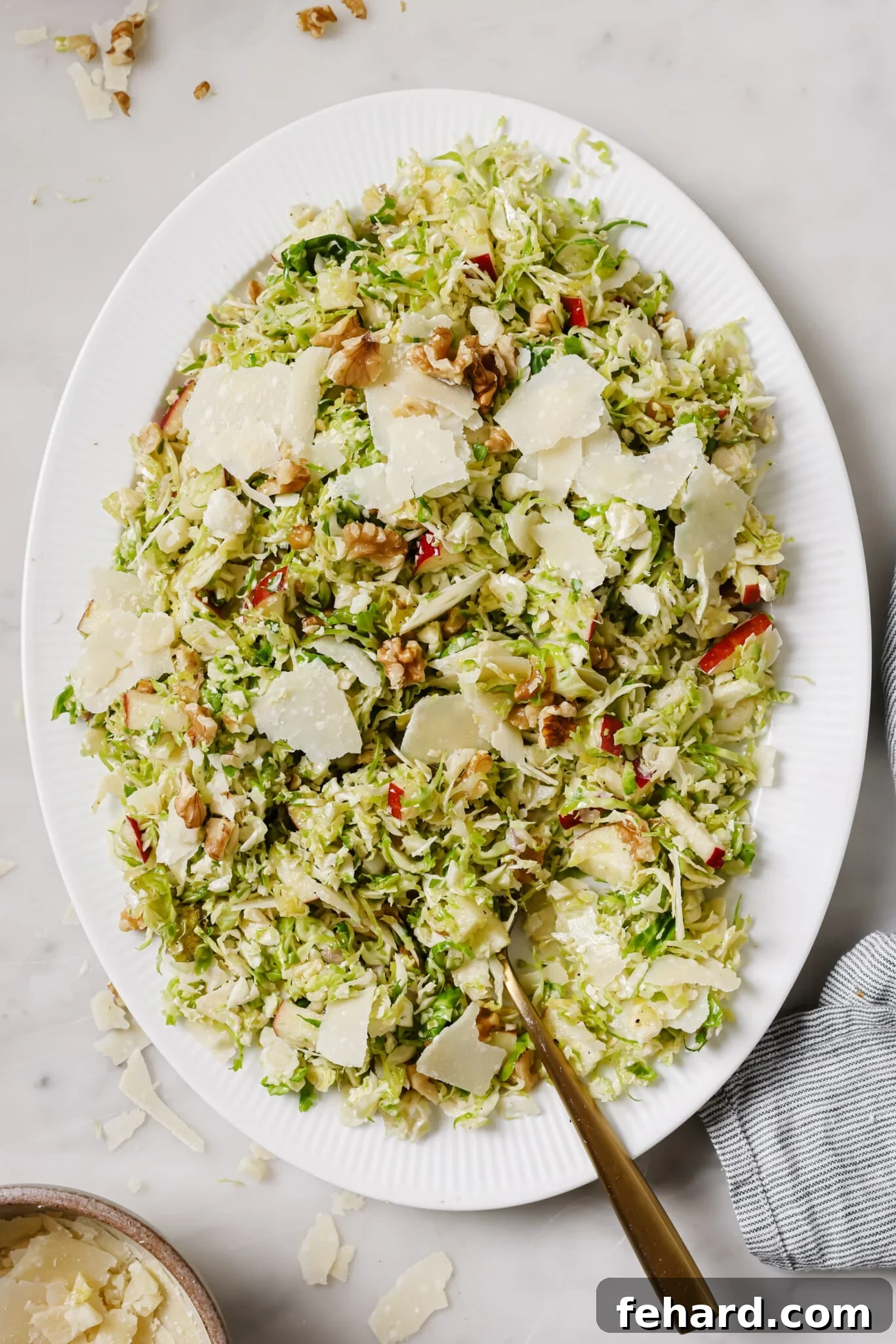 Crisp Shaved Brussels Sprout Slaw 6 Shaved Brussels Sprouts Salad on a serving dish.