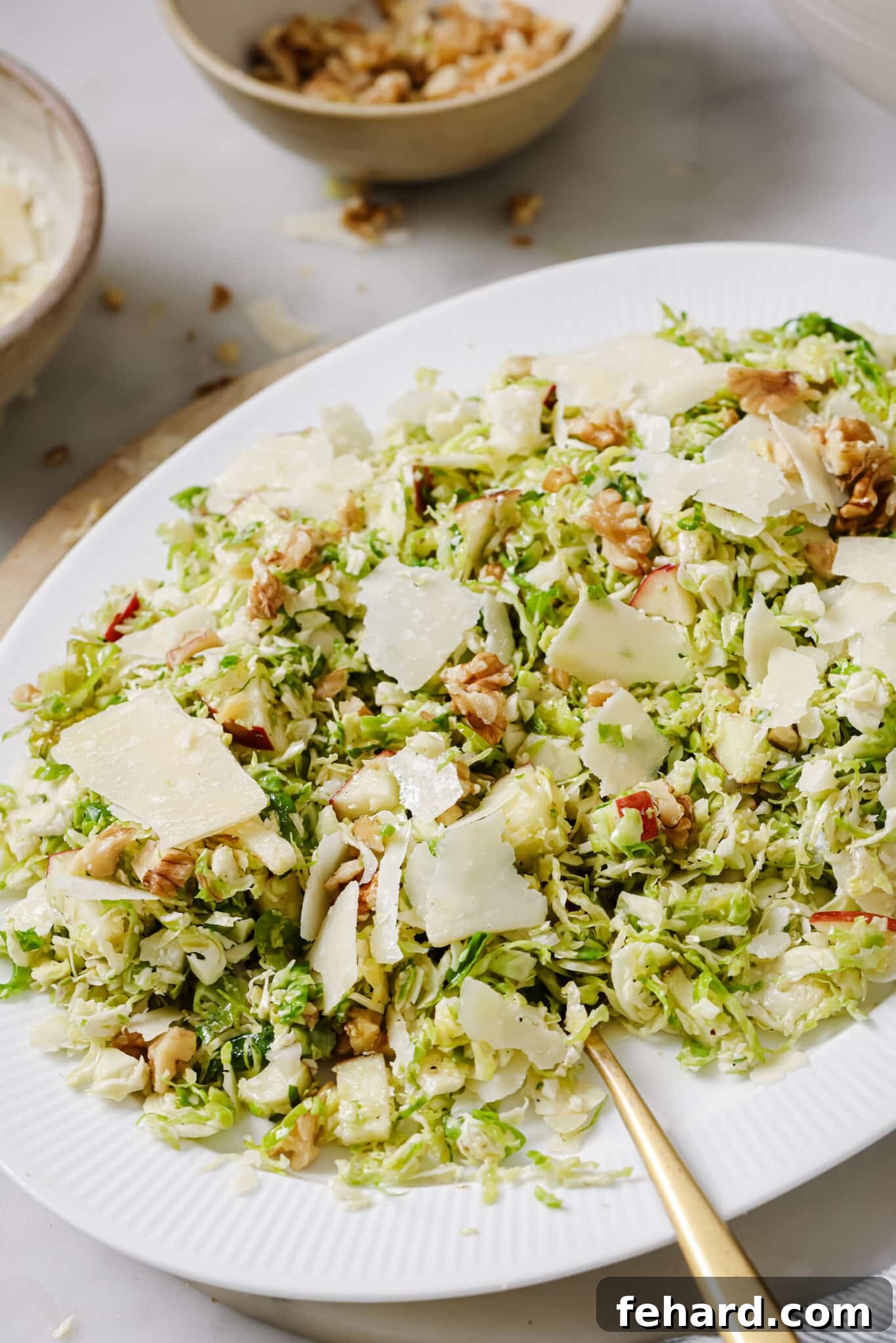 Crisp Shaved Brussels Sprout Slaw 7 Shaved Brussels Sprouts Salad on a serving dish.