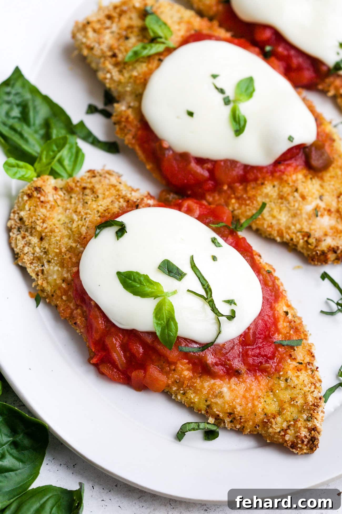 Homestyle Chicken Parmesan Bake 6 Baked chicken parmesan on a white serving plate.
