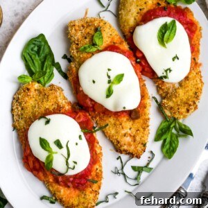 Homestyle Chicken Parmesan Bake 8 Overhead view of baked chicken parmesan on a white plate