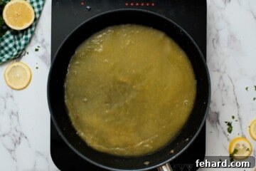 Zesty Honey-Glazed Skillet Chicken 6 Honey lemon chicken sauce simmering in saute pan.