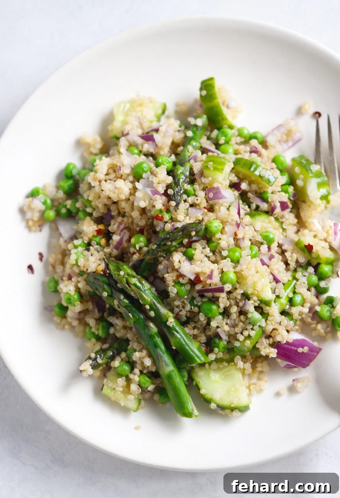 Close-up of fresh Spring Quinoa Salad ingredients including cucumber, peas, and red onion.