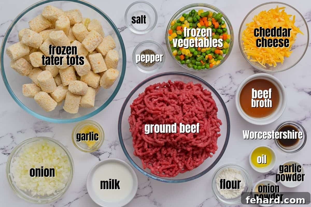Fresh ingredients for Tater Tot Casserole, including ground beef, mixed vegetables, onions, garlic, and cheese, neatly arranged on a kitchen counter.