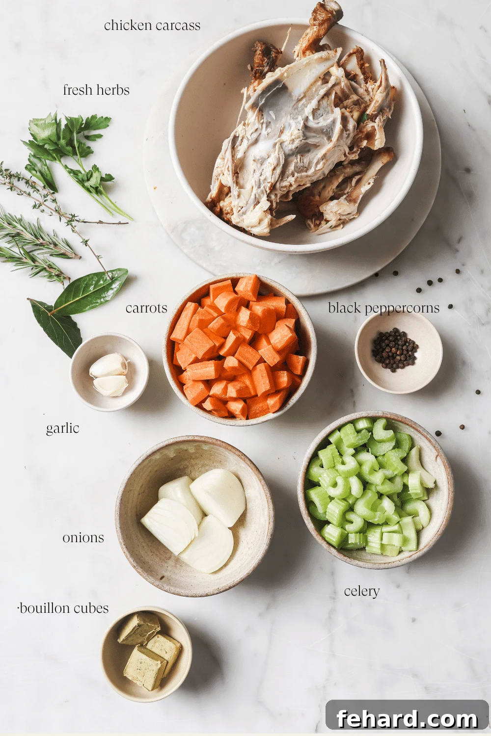 Pre-measured ingredients for homemade chicken broth, including vegetables, herbs, and peppercorns, arranged in small bowls.