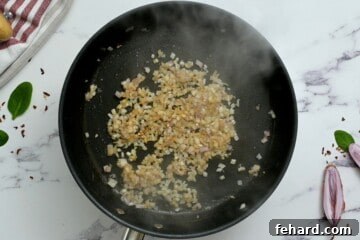 Creamy Florentine Chicken 5 Minced shallot being sautéed in butter in a hot skillet.