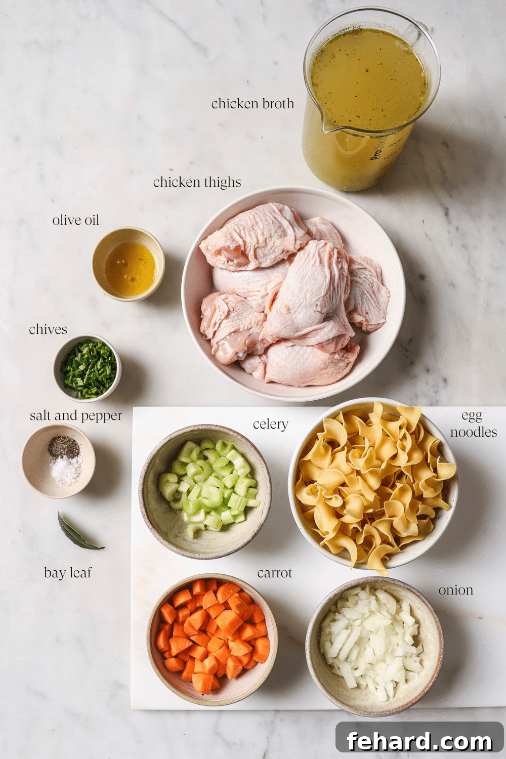 Pre-measured ingredients for slow cooker chicken noodle soup laid out in small bowls.