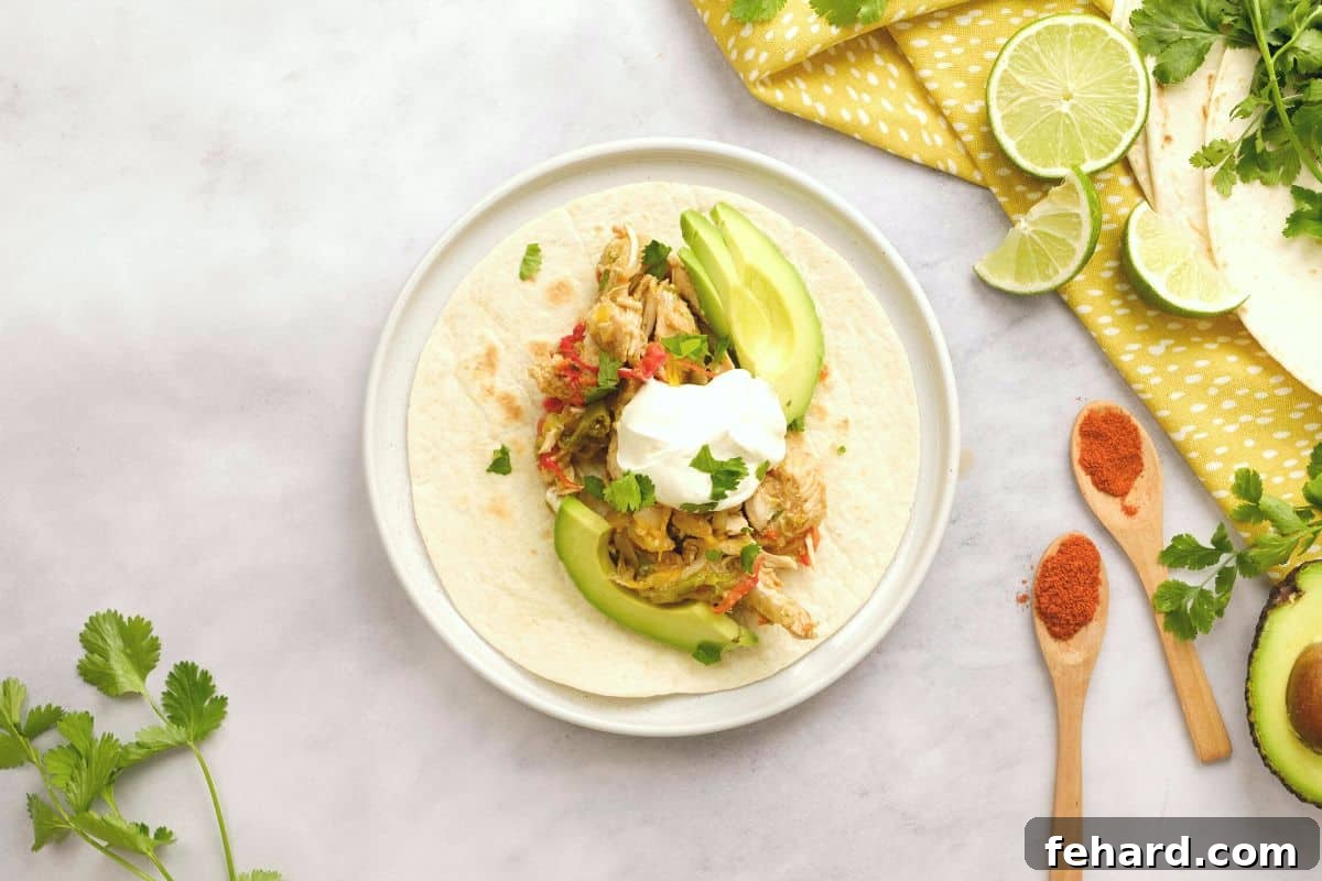 Chicken fajita mixture served on a warm flour tortilla, topped with sour cream and sliced avocado.