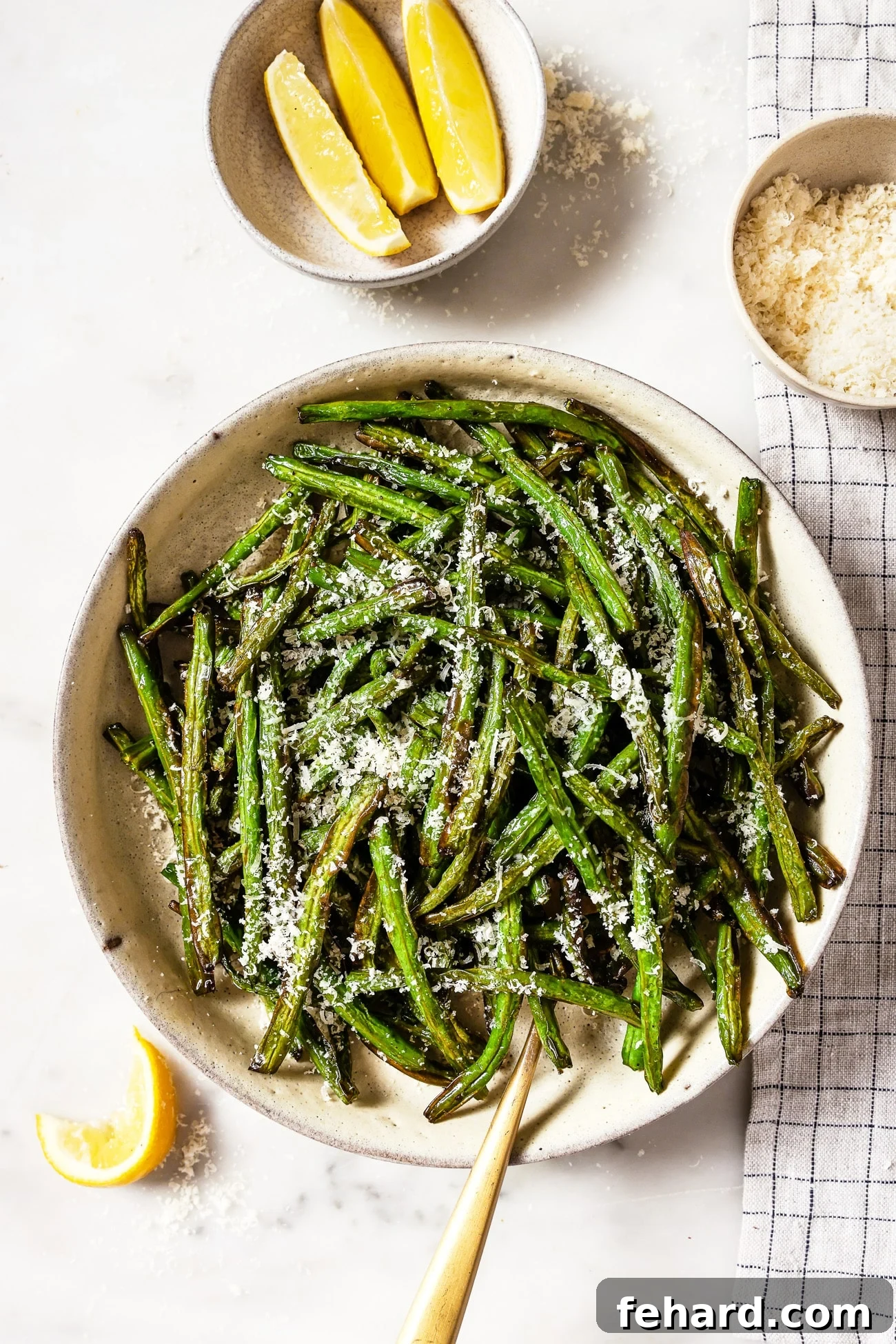 Crispy Air Fried Green Beans 2 A bowl of air fryer green beans with parmesan cheese on top.