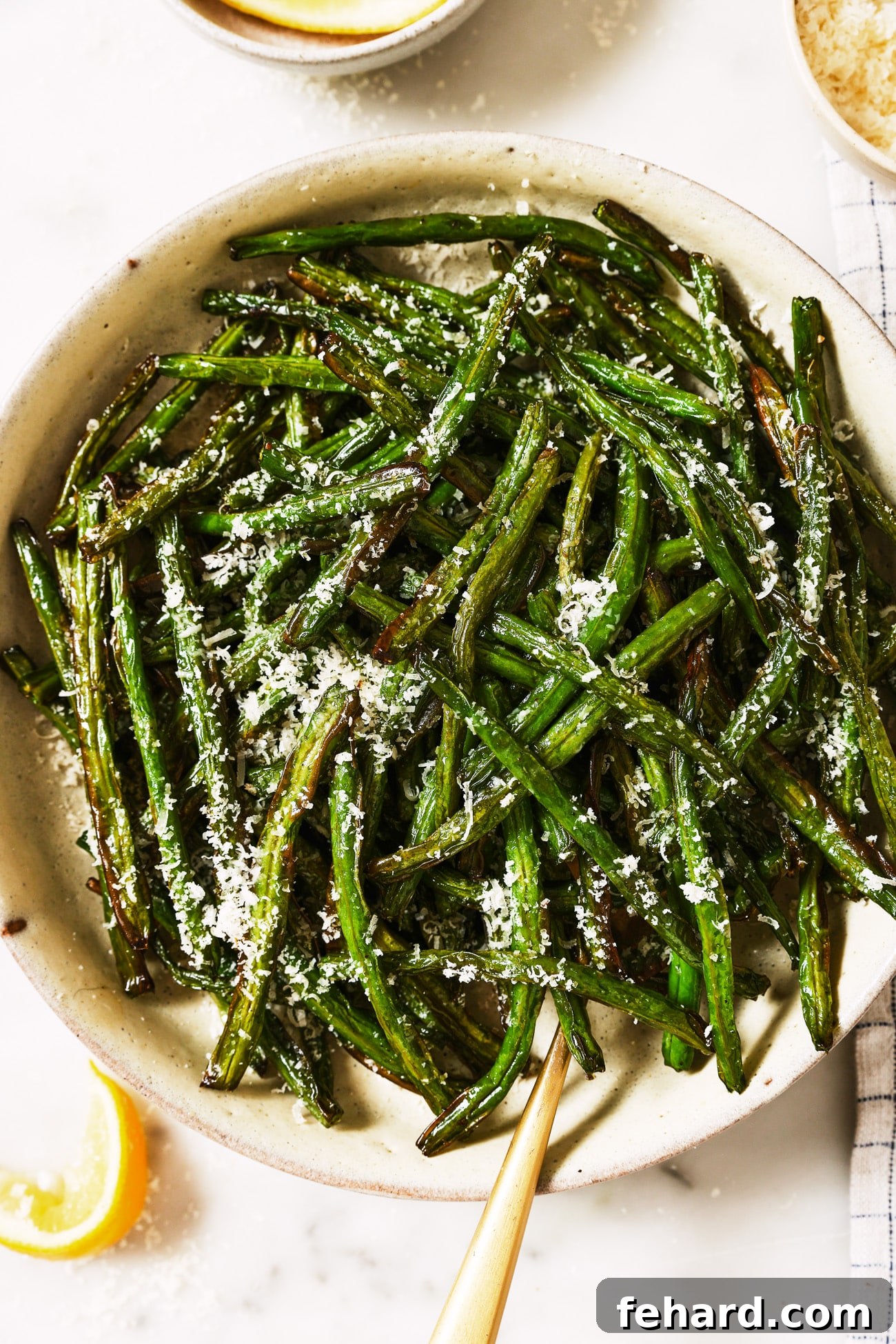 Crispy Air Fried Green Beans 9 A bowl of air fryer green beans with parmesan cheese on top.