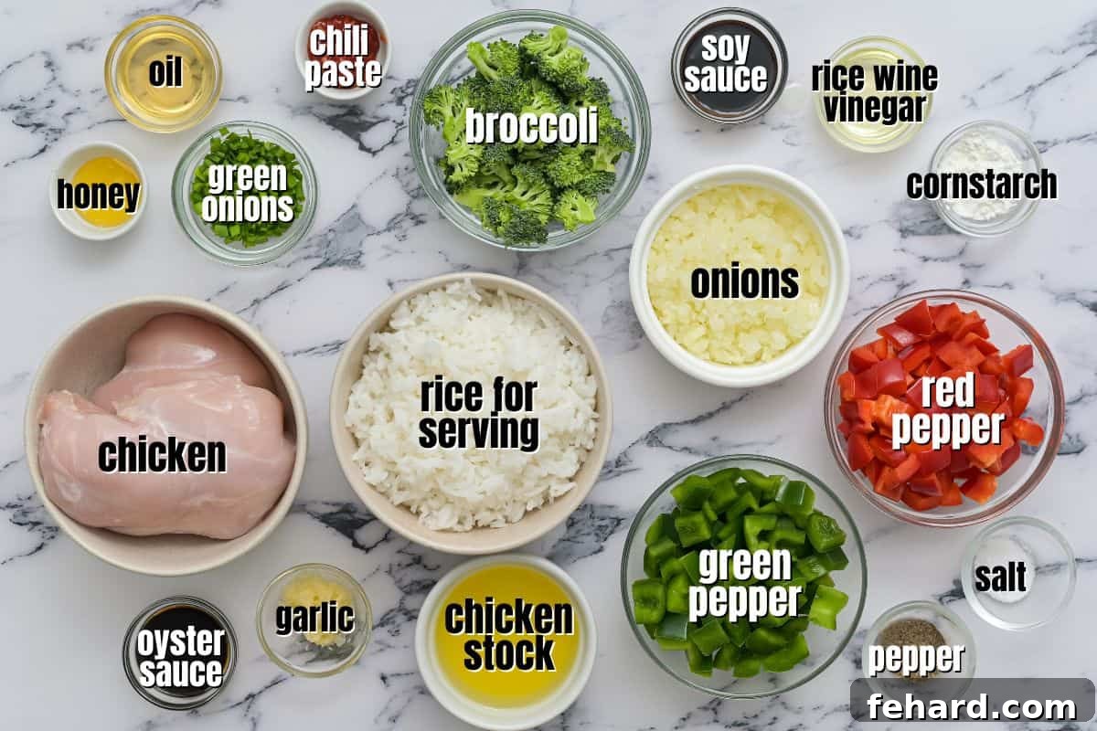 Easy Hunan Chicken Recipe Neatly arranged ingredients for Hunan Chicken on a kitchen counter, showcasing fresh produce, chicken, and sauce components.