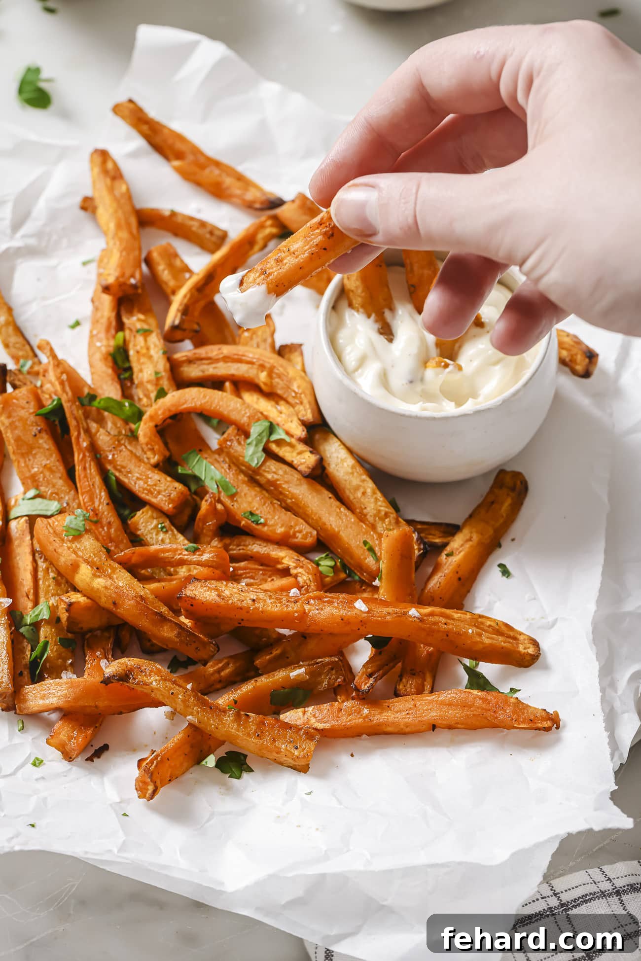 Crispy Air-Fried Sweet Potato Perfection 8 Air fryer sweet potatoes with dipping sauce on the side.