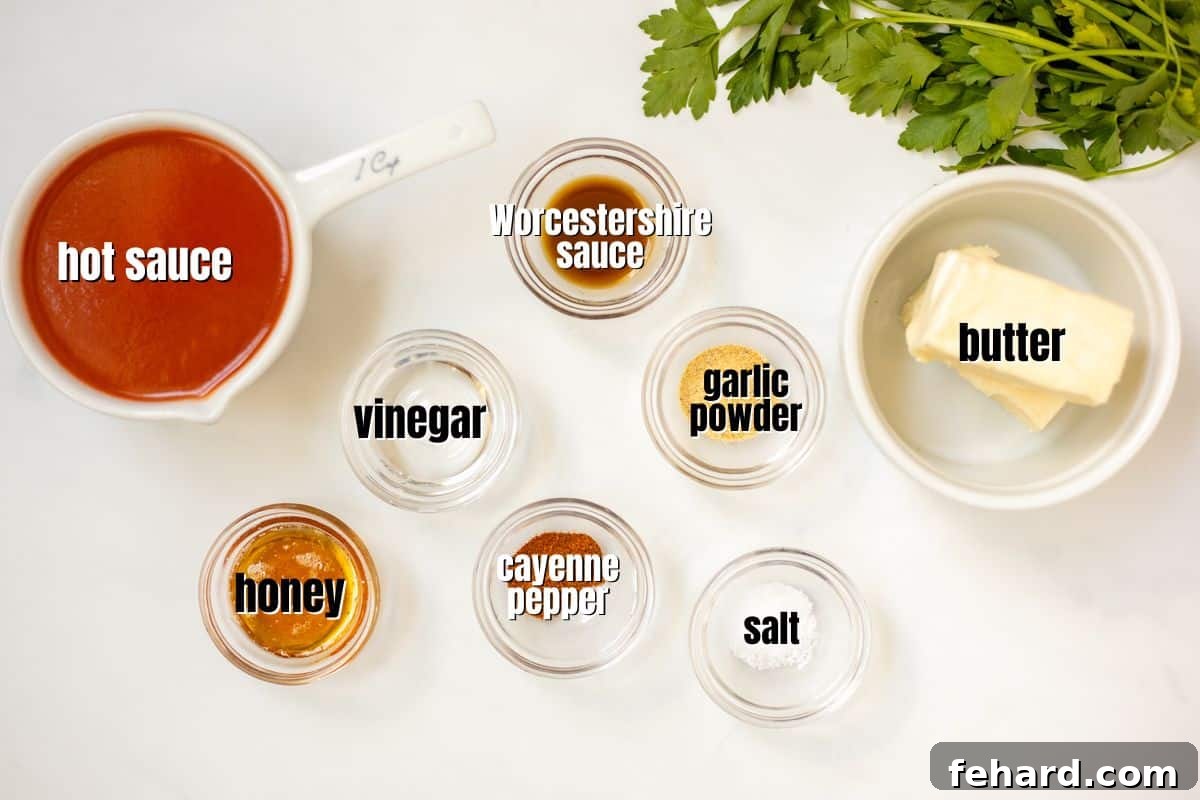 Various ingredients for making buffalo sauce neatly arranged on a kitchen counter, each labeled clearly, ready for preparation.