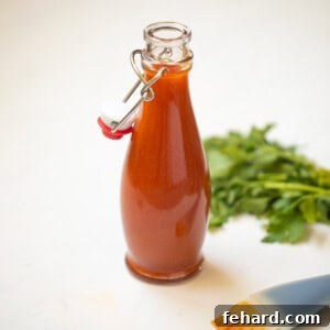 Buffalo Sauce in jar with a pastry brush in the background, ready for application.