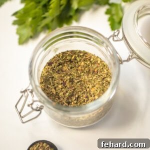 Jar of homemade Italian Seasoning on counter next to teaspoon measuring spoon.