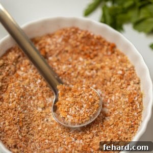 Close up of dry rub mixed together in small white bowl with spoon showing dry rub.
