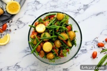 Ingredients for Italian Potato Salad tossed together in large mixing bowl.