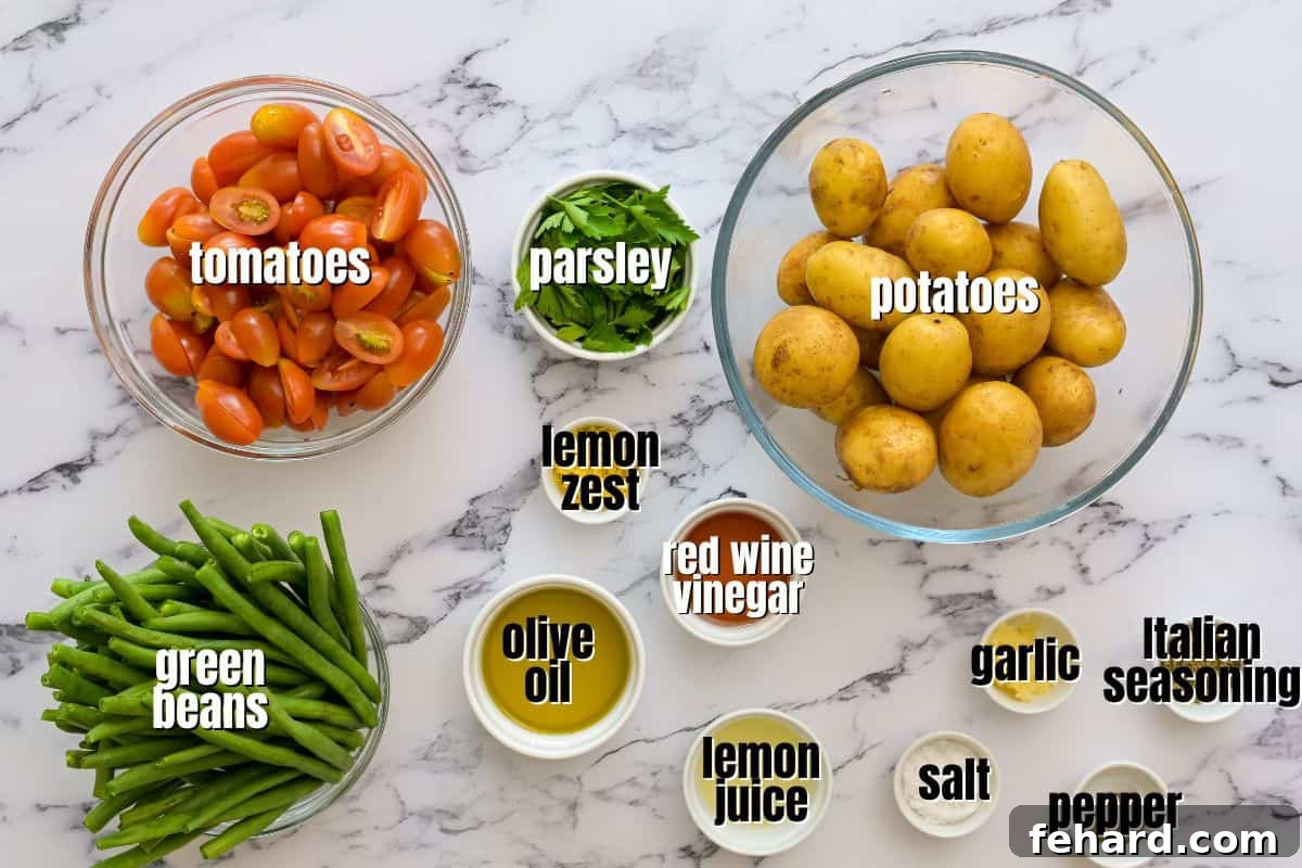 An organized display of fresh ingredients for Italian potato salad: baby potatoes, green beans, cherry tomatoes, lemon, garlic, and fresh parsley on a kitchen counter.