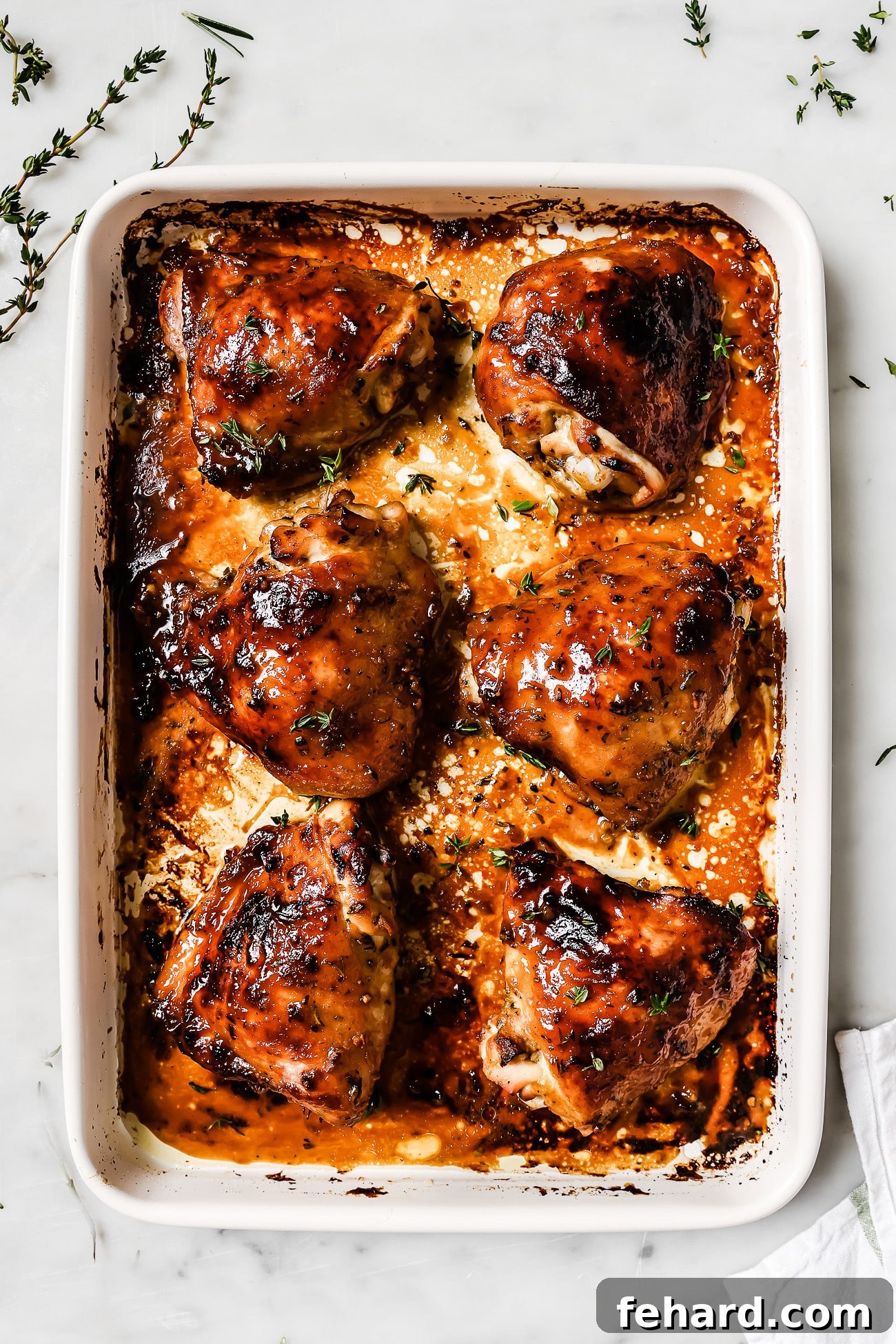 Golden Glazed Honey Mustard Chicken 7 Honey mustard chicken thighs in a baking dish.