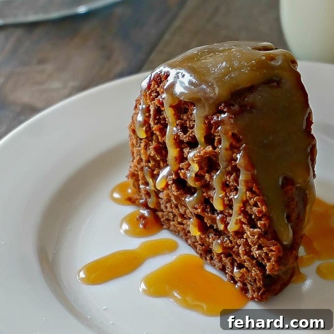 Close-up of a Slice of Moist Chocolate Bundt Cake with generous Salted Caramel Glaze, garnished with a sprinkle of sea salt