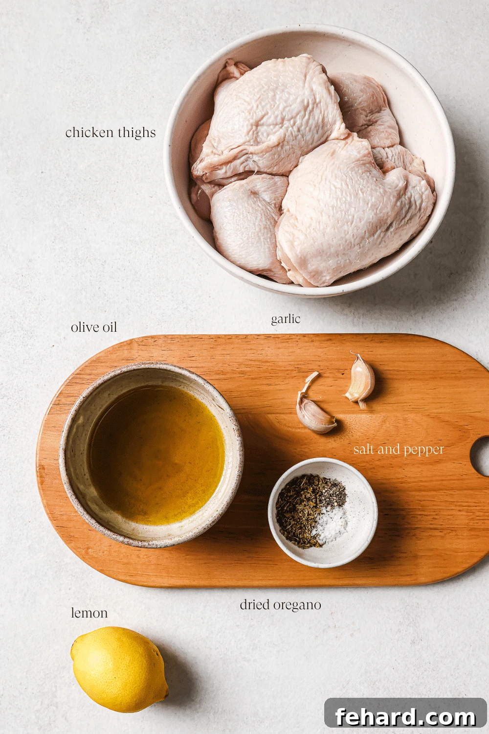 Zesty Lemon Chicken Thighs 3 Pre-measured fresh ingredients for the lemon chicken thighs marinade, including vibrant lemons, garlic, olive oil, and bone-in chicken thighs, neatly arranged for preparation.