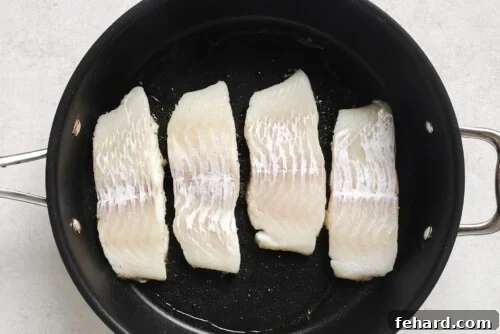 Pan-Seared Garlic Butter Haddock 11 raw Haddock fillets in a skillet