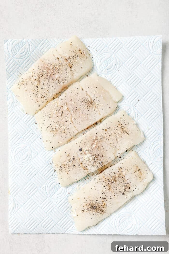 Pan-Seared Garlic Butter Haddock 4 Raw Haddock fillets on a countertop