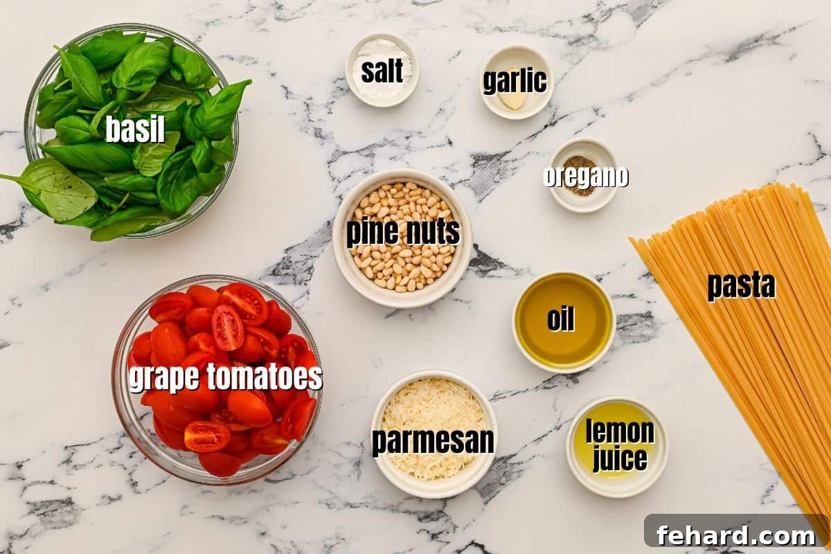 Labeled ingredients for Pesto pasta laid out on a kitchen counter: pasta, basil, tomatoes, lemon, Parmesan, olive oil.