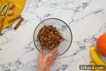 The delicious streusel topping, a perfect mix of oats, nuts, brown sugar, and butter, prepared in a small bowl.