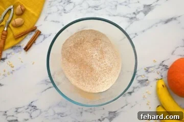 Sifted flour and spices expertly whisked together in a spacious mixing bowl.