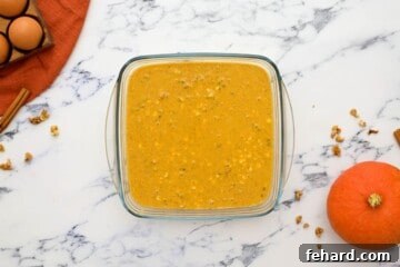 Pumpkin oatmeal poured into 8x8 glass baking dish.