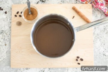Saucepan with espresso, pumpkin spice, vanilla, and pumpkin puree mixed together after simmering.