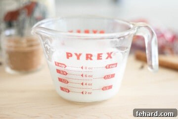 Milk frothed in pyrex glass mixing cup.