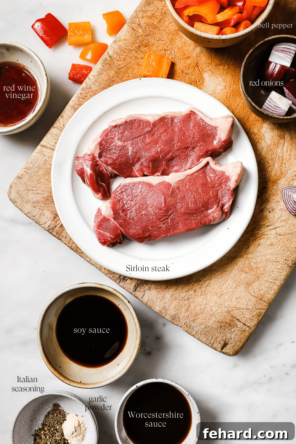 Two sirloin steak pieces on a white plate and small bowls of pre-measured marinade ingredients, including soy sauce, red wine vinegar, Worcestershire sauce, and spices.