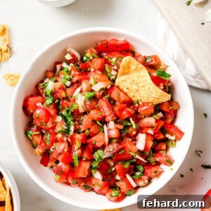A close-up shot of the vibrant Pico de Gallo in a large bowl, showcasing its fresh ingredients and inviting colors.
