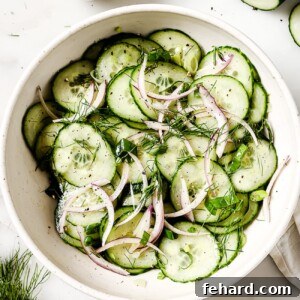 A close-up shot of a vibrant cucumber salad in a bowl.