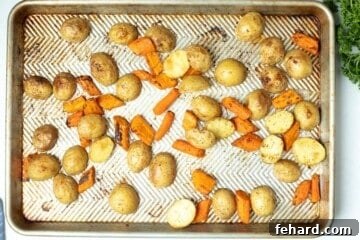 Roasted potatoes and carrots on sheet pan.