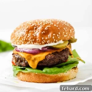 close up of a hamburger on a parchment paper.