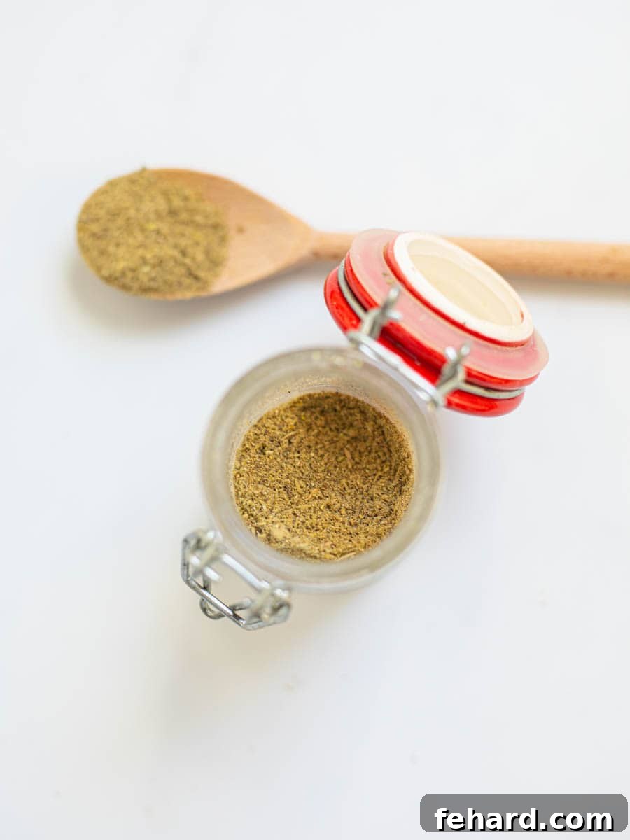 Homemade Poultry Seasoning A glass jar filled with homemade poultry seasoning, ready for use.
