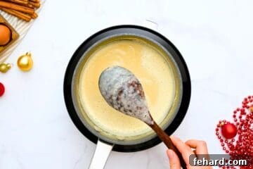 Wooden spoon coated with thick non dairy homemade eggnog.