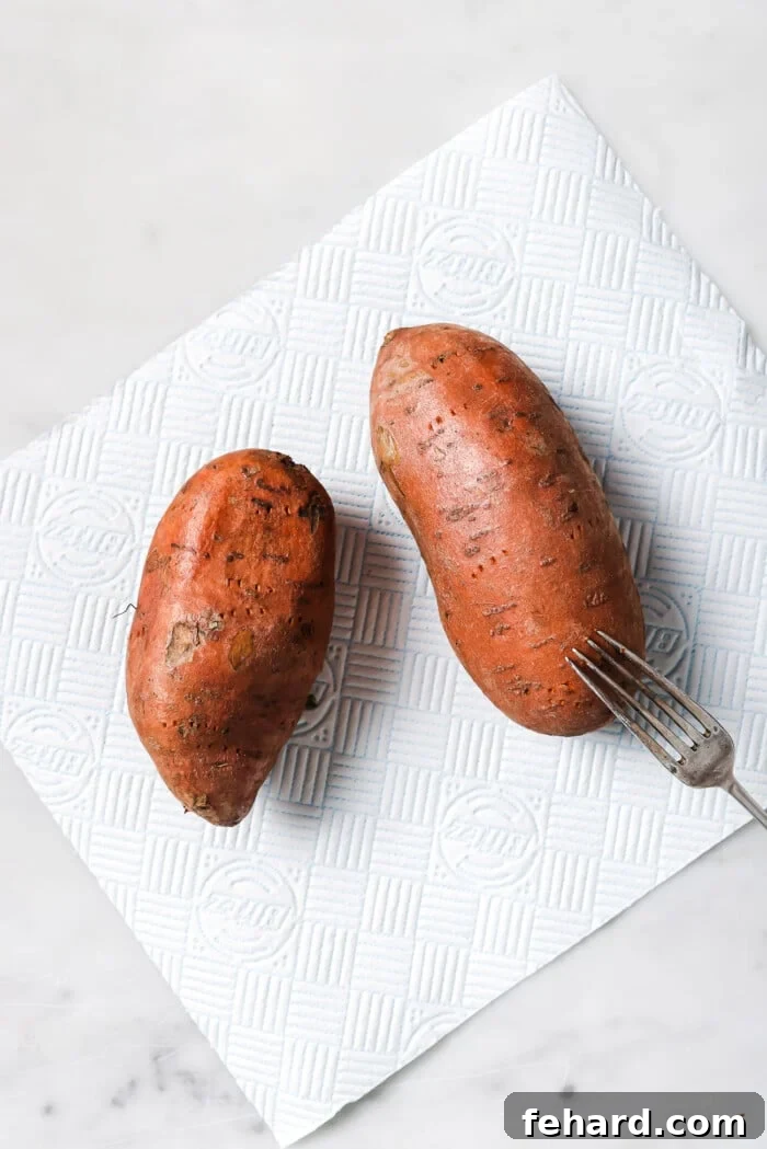 two sweet potatoes on a countertop