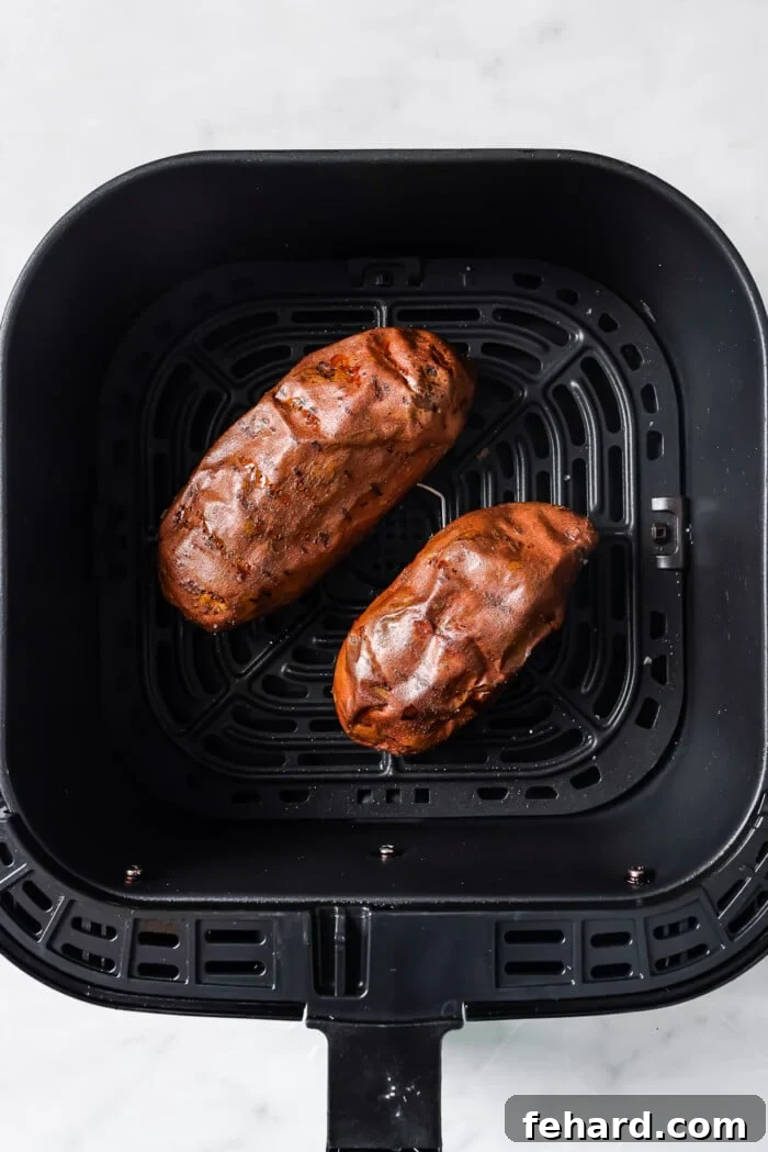 cooked sweet potato in a air fryer basket 