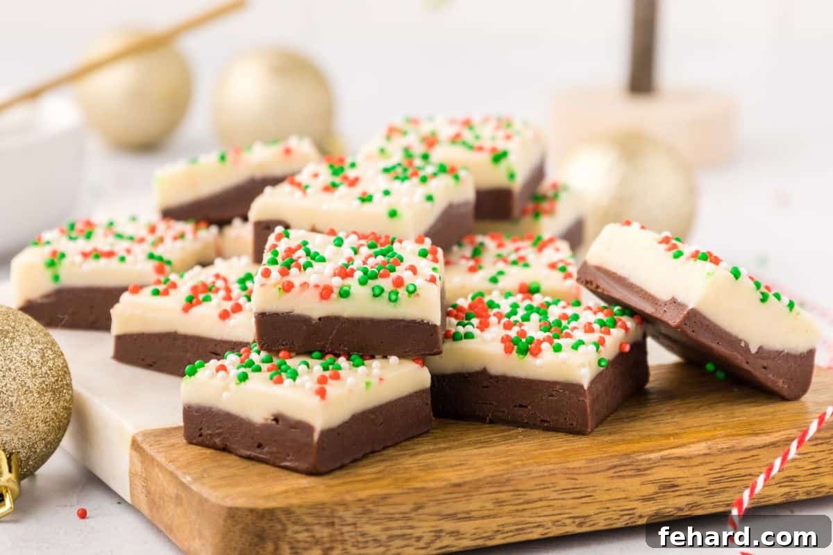 Layered fudge with holiday christmas sprinkles on cutting board.