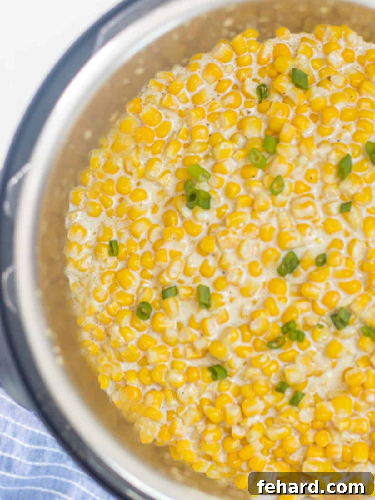Creamed Corn inside inner pot of an Instant Pot, steaming slightly.