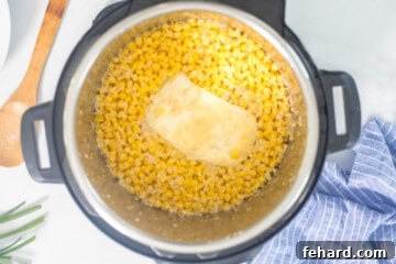 Instant Pot with creamed corn ingredients after pressure cooking but before stirring together.
