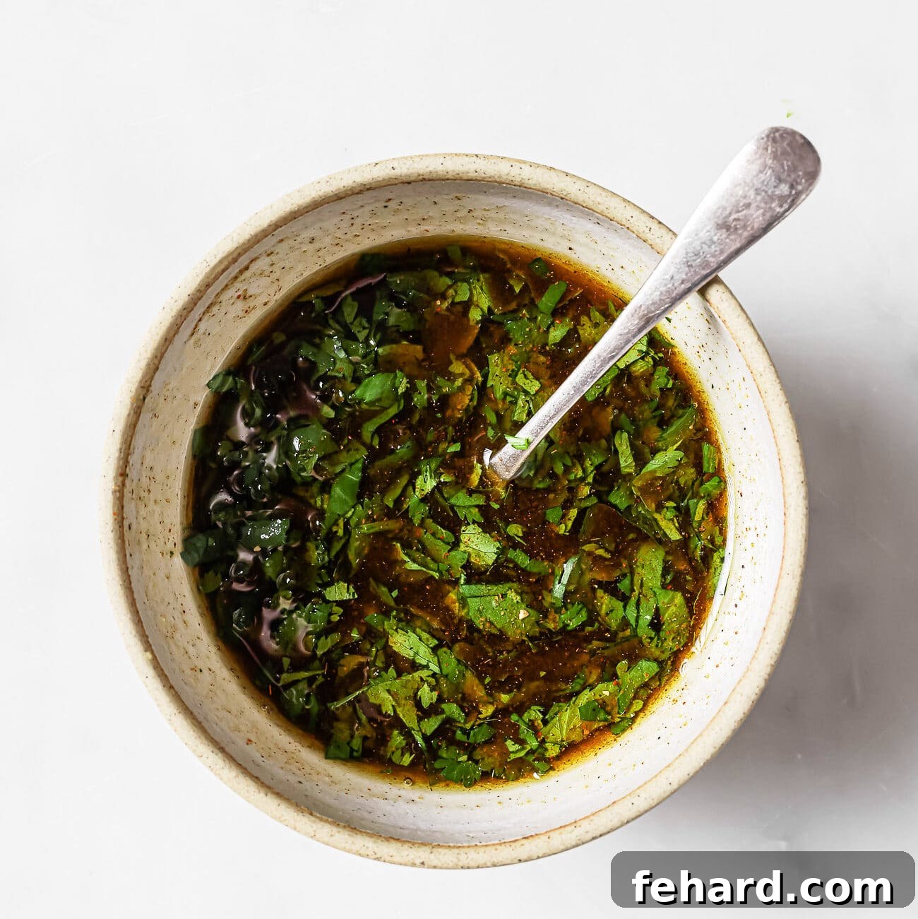 An overhead view of carne asada marinade in a mixing bowl. 