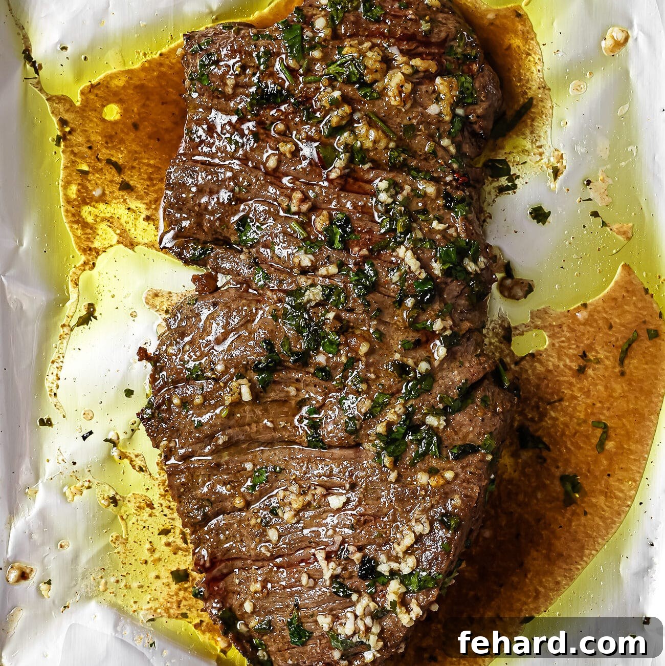 Baked carne asada on a foil-lined baking sheet. 