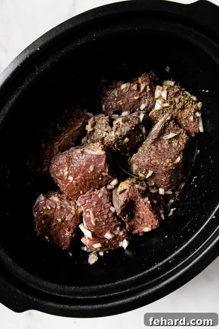 Beef tossed in seasonings and bay leaves added.
