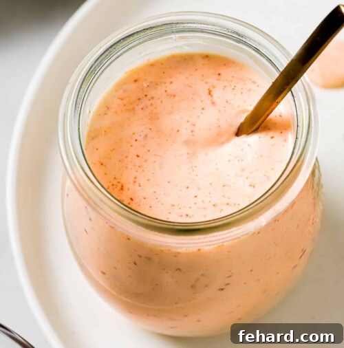 Homemade Smoky Chipotle Sauce 9 closeup view of chipotle sauce in a glass little jar.