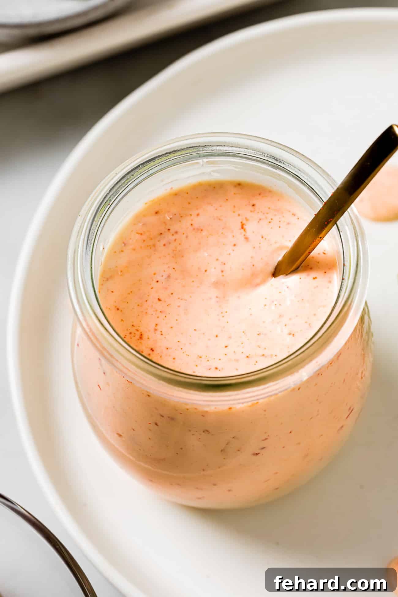 Homemade Smoky Chipotle Sauce 5 Chipotle sauce in a small glass jar with a spoon in it.